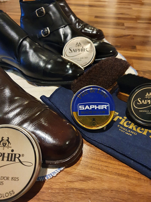 Collection of mens leather boots after a shoeshine and Saphir wax polish